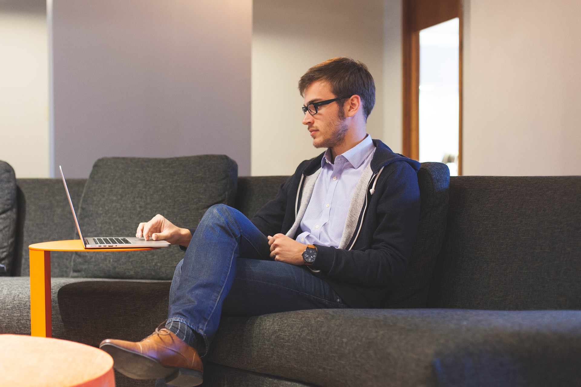 a man at home on his couch working on his communication skills