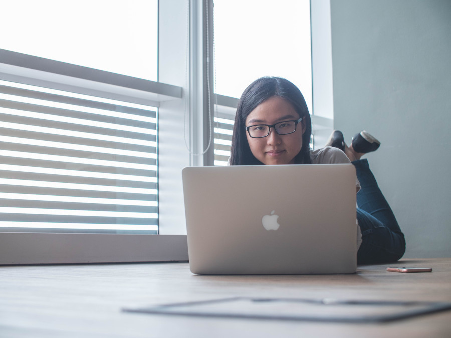 a woman at home on her laptop doing voice therapy