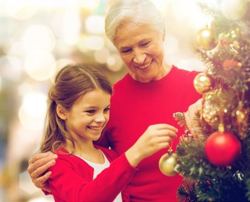 grandmother and granddaughter at christmas tree