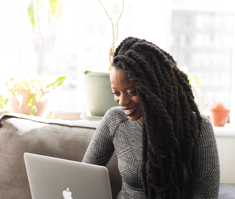 a woman with Spasmodic Dysphonia at home on her laptop