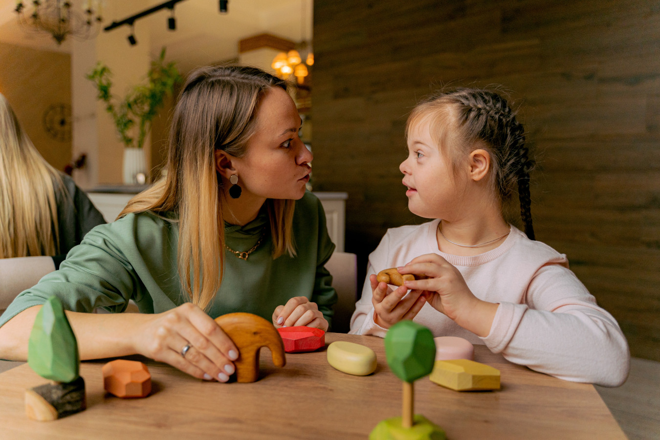 Down Syndrome girl playing with wooden blocks