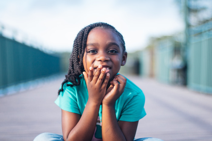 a child looking at the camera who has suffered hearing loss