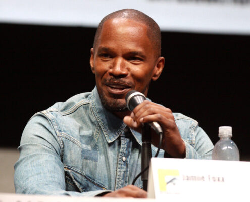 jamie foxx on a microphone speaking to an audience