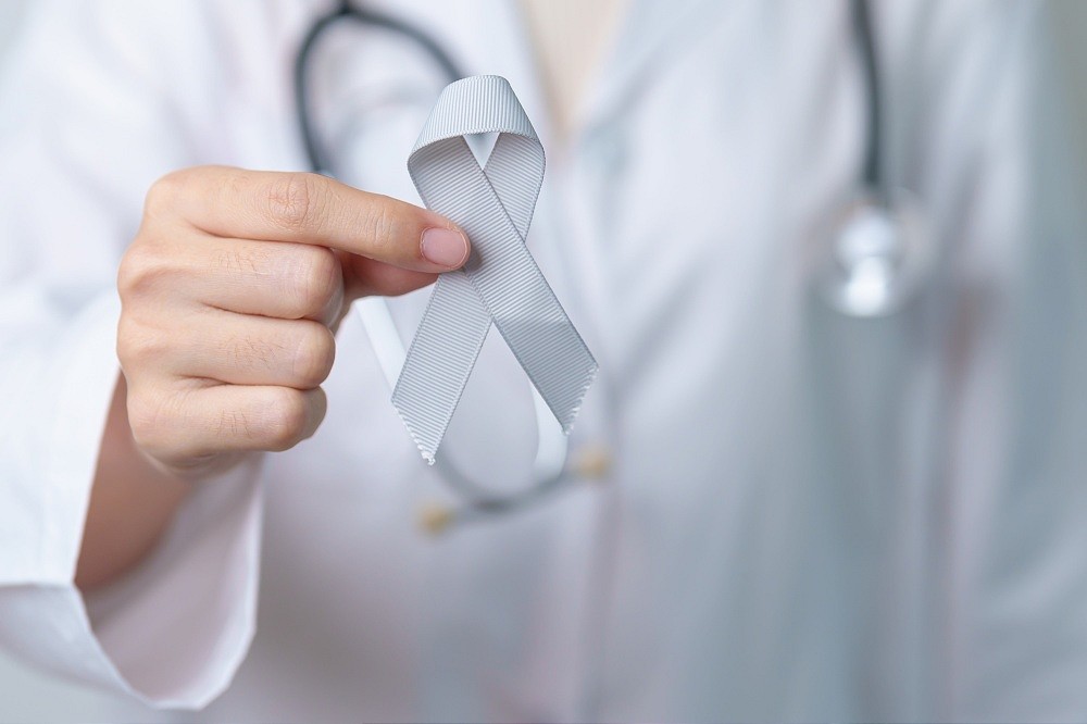 doctor holding a grey ribbon