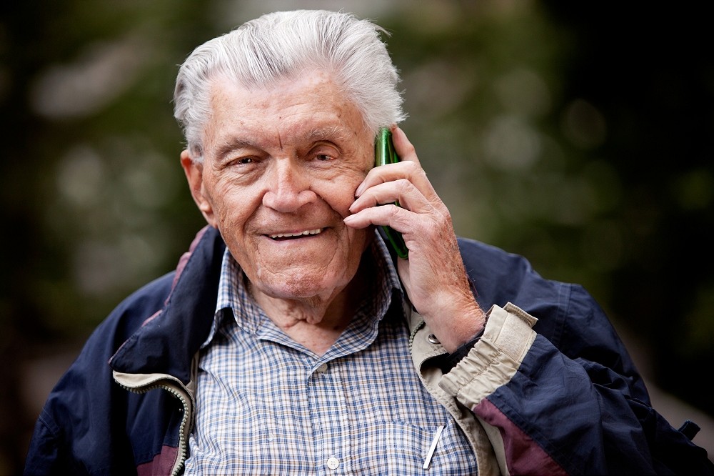 an elderly man on his cell phone