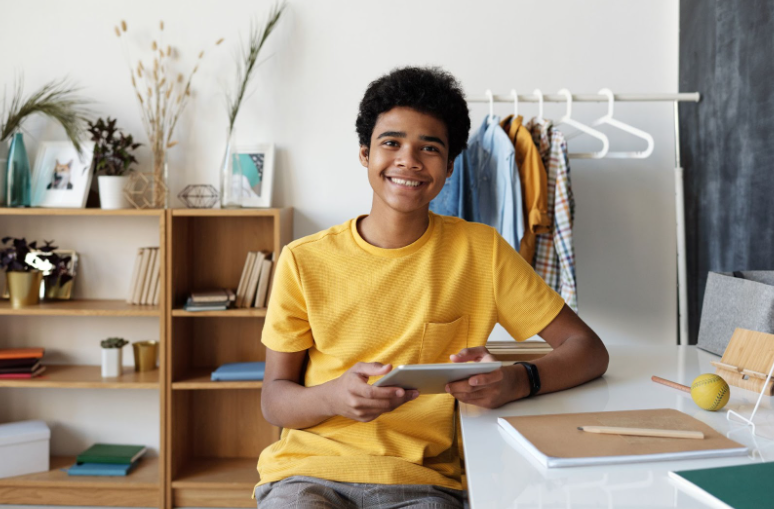 young man on a tablet computer at home while learning