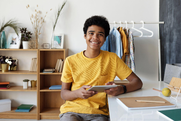 teenage boy at home on a tablet computer doing speech therapy