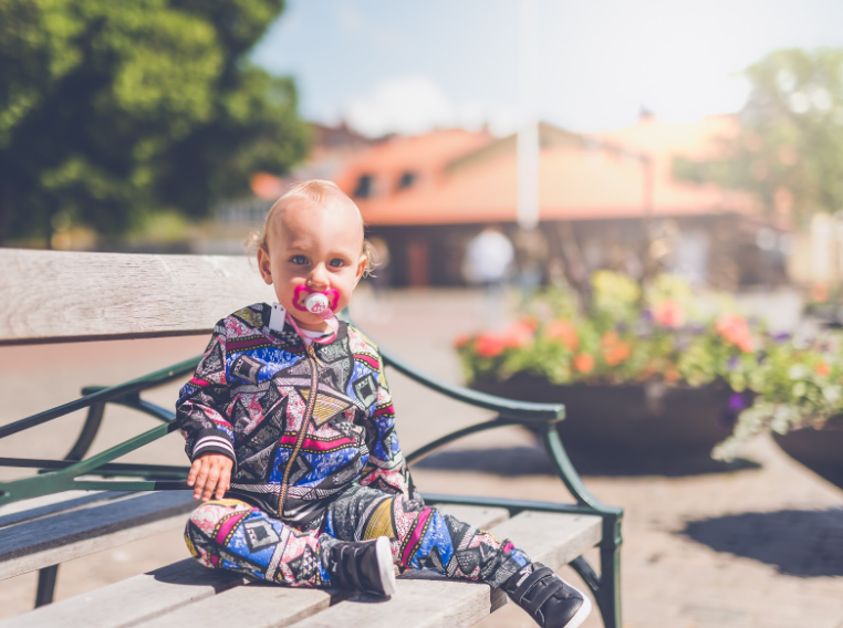 A child sitting on a park bench