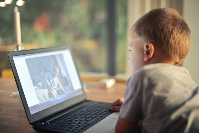 oral motor skills being practiced at home by a boy on his laptop