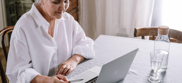 a woman suffering from TBI is at home on her laptop