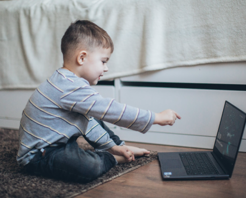 child using his laptop at home to help improve his speech