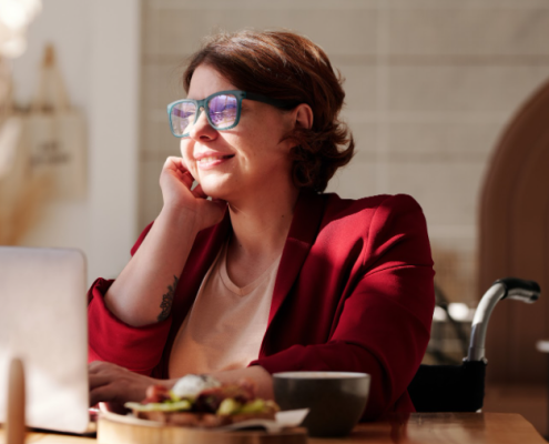 A woman with cerebral palsy sitting at a table