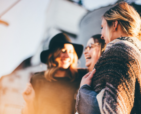 three women enjoying each others company laughing