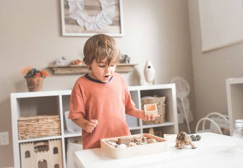 boy with ADHD playing with his learning toys at home
