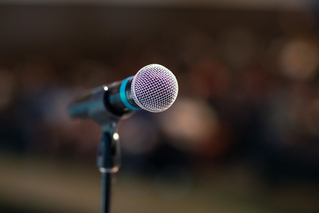 an image of a microphone before someone does a speech