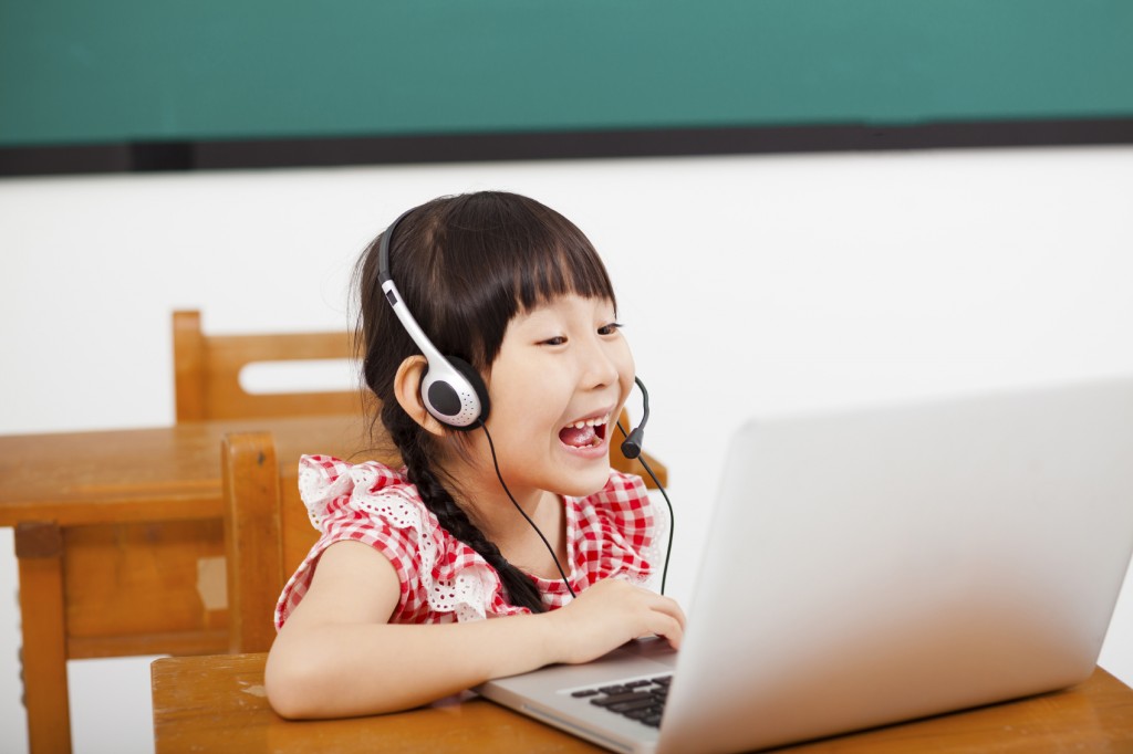 a bilingual child at home on a laptop