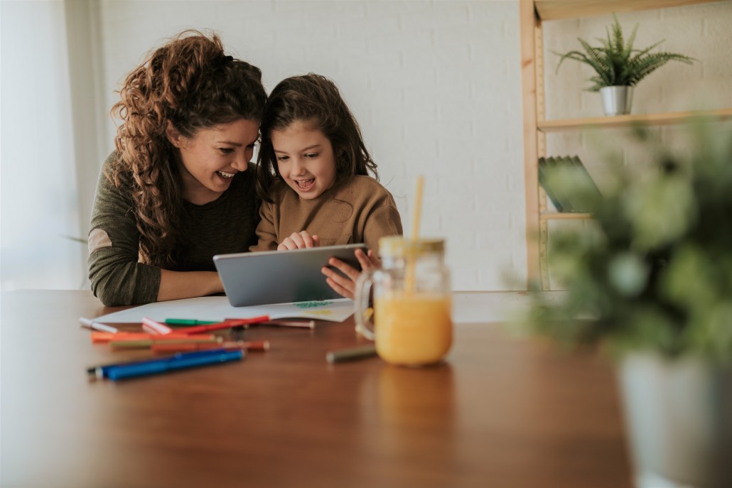 child with a parent learning at home during the pandemic