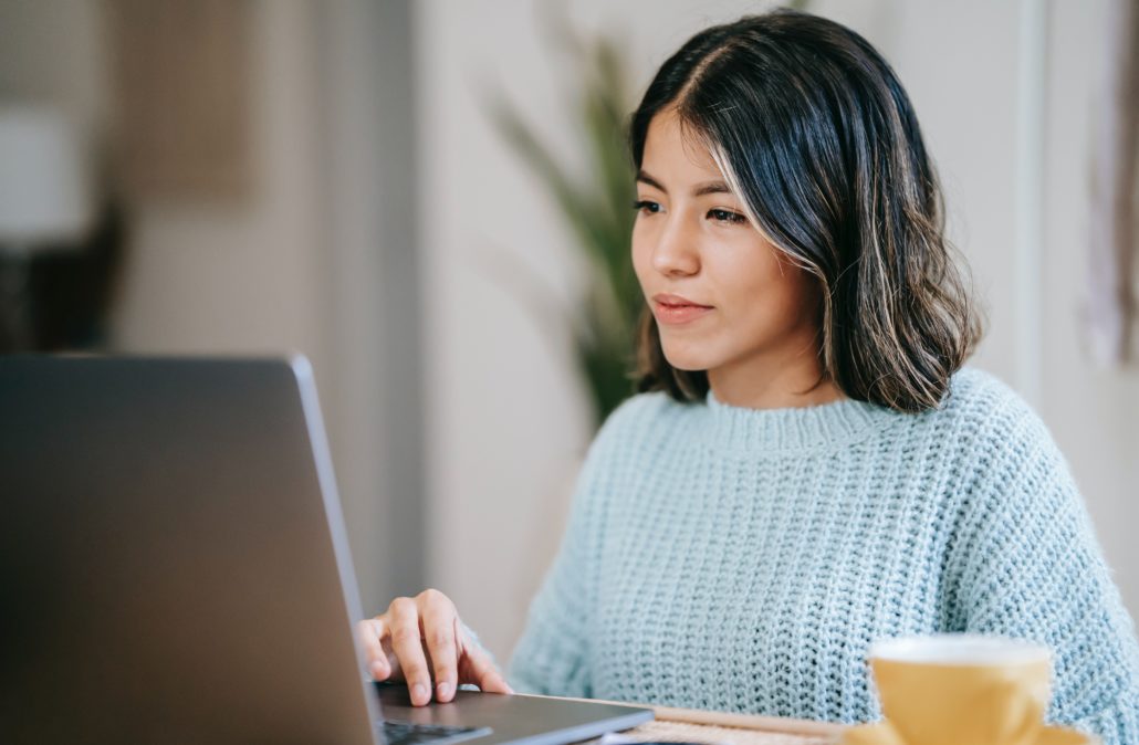 woman with Orofacial-Myofunctional-Disorder on her laptop at home