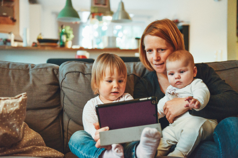 a mother with her kids at home practicing speech