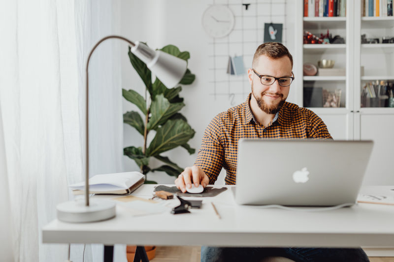 man at home on a laptop learning about speech therapy