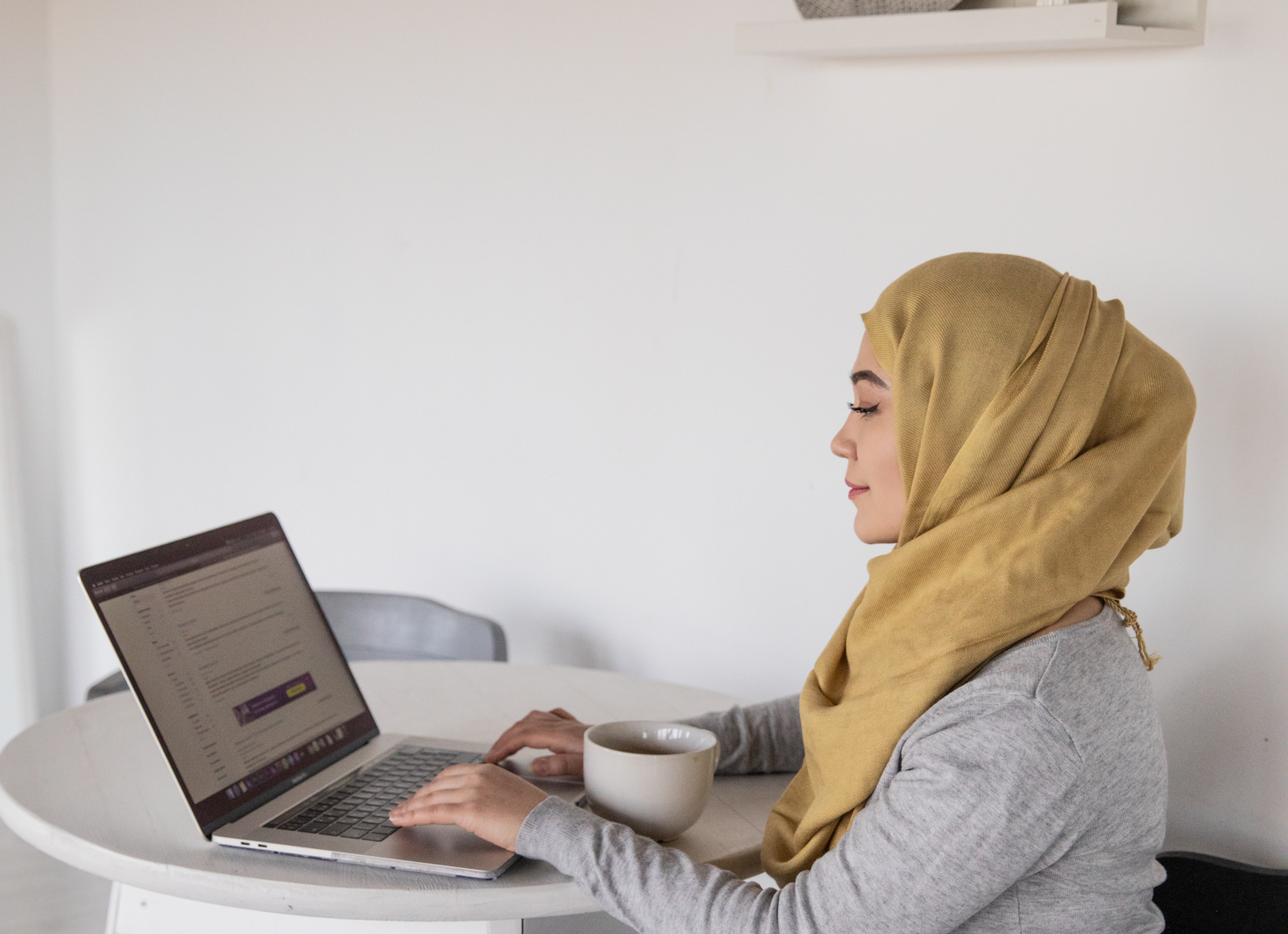 a woman at home getting voice therapy from her laptop