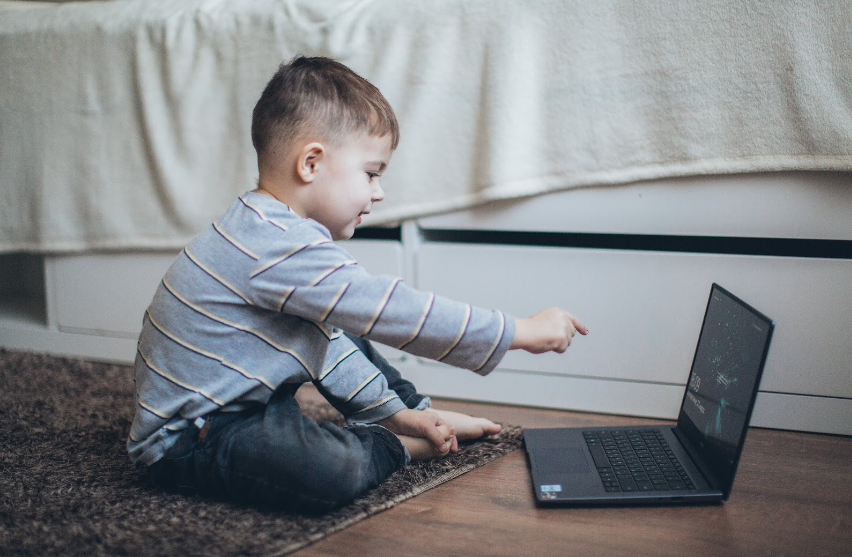 child using his laptop at home to help improve his speech